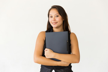 Attractive content woman holding folder. Beautiful cheerful young female student holding folder and smiling at camera on white background. Education concept