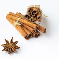 Spices: star anise and cinnamon sticks on white background. Close up. Top view.