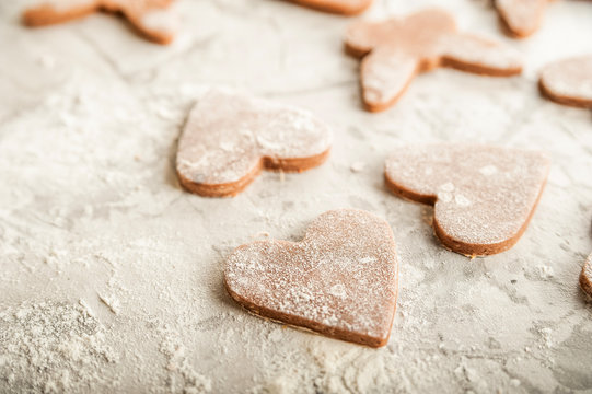 The texture of the dough closeup. Heart shaped gingerbread baking. Homemade cookies for Valentines Day and copy space. Keto baking.