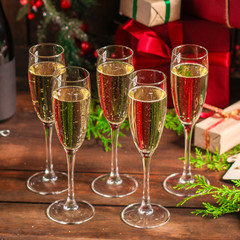 champagne and new year, christmas or noel (champagne glass, sparkling wine and gifts on the table) menu concept. food background. copy space. Top view