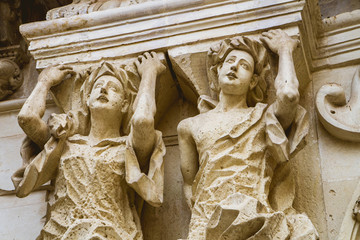 Baroque details of the facade of the Basilica of the Holy Cross in Lecce Italy