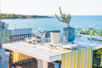 Beautiful tropical restaurant and beach with turquoise water. Corfu island, Greece.