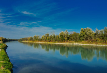 Fototapeta na wymiar The river Inn near Rosenheim in Upper Bavaria, trees in autumn colors on the opposite shore