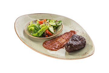 Grilled Beef Steak with tomato sauce and fresh vegetable salad isolated on white background