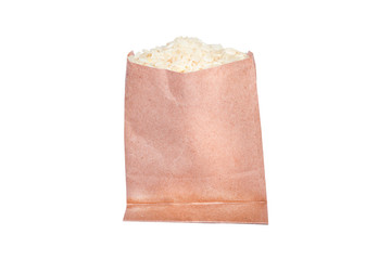 White rice cereal in brown paper bag with empty space for text, healthy food theme, isolated on white background
