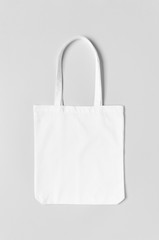 White tote bag mockup on a grey background.