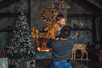 dad throws up his son in the new year. The boy is laughing