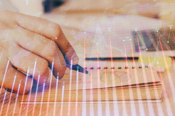 Multi exposure closeup hands with stock market forex graph.