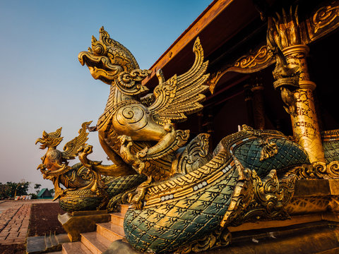 Amazing Temple Sirindhorn Wararam Phuproud in Ubon Ratchathani Province at twilight time,Thailand.Thai temple with grain and select white balance.Night sky effect for Long exposure photo taken.