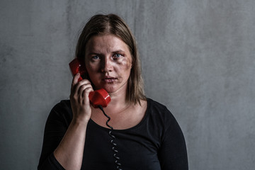 Woman victim of domestic violence and abuse asks for help by phone. Empty space for text