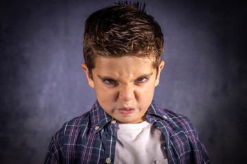 Angry child. Little boy with an angry expression.