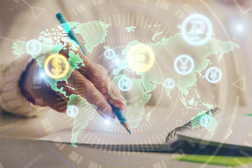 Financial forex graph displayed on hands taking notes background. Concept of research. Double exposure