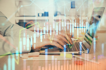 Double exposure of stock market graph with man working on laptop on background. Concept of financial analysis.