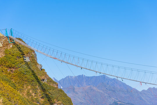 View of the cableway in the mountains over a high precipice.