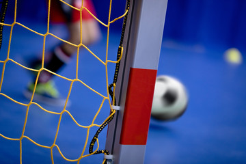 Indoor Soccer Background. Futsal Junior Player on Indoor Training. Soccer Goal with Yellow Net....