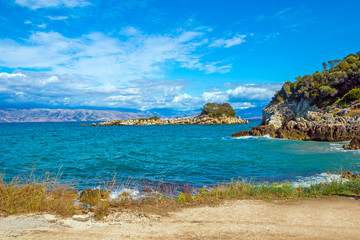 Rocky beach landscape on summer day, Beautiful turquoise color sea water. Corfu, Greece.