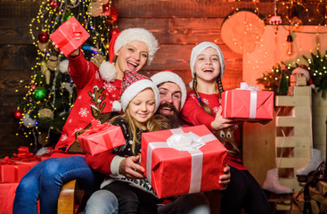 Obraz na płótnie Canvas Christmas joy. Happy holidays. Parents and children opening christmas gifts. Father Santa claus and mother little daughters christmas tree background. Christmas tradition. Family bonding activities