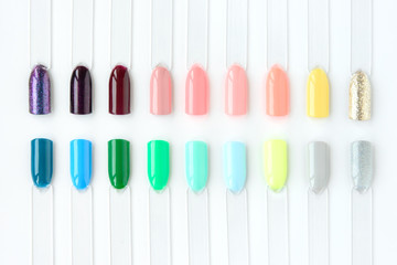 Nail polish samples in different bright colors. Colorful nail lacquer manicure swatches. Top view of nail art samples palette. Free copy space. - 299523338
