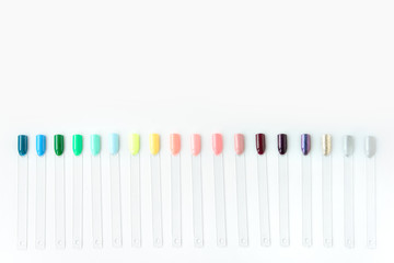 Nail polish samples in different bright colors. Colorful nail lacquer manicure swatches. Top view...