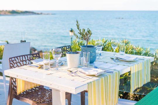 Beautiful tropical restaurant and beach with turquoise water. Corfu island, Greece.