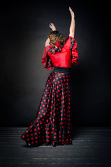 Carmen beautiful woman in red dress on dark background