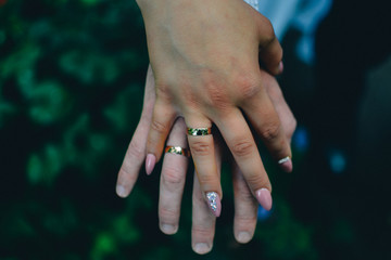 hands of the newlyweds with wedding rings