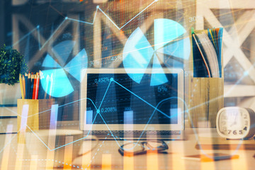Financial graph colorful drawing and table with computer on background. Double exposure. Concept of international markets.