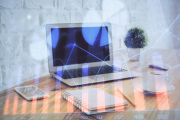 Stock market graph and table with computer background. Double exposure. Concept of financial analysis.