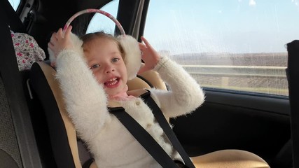 little girl in car child seat, family car journey