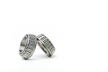 background of auto parts on a white background. tapered bearings on white background