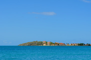 Naklejka premium Distant view of Caribbean village with colorful roofs