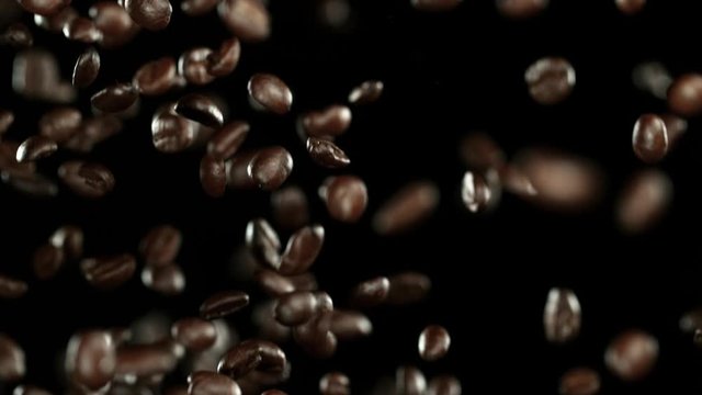 Super slow motion of flying coffee beans in speed ramping. Filmed on high speed cinema camera, 1000 fps.
