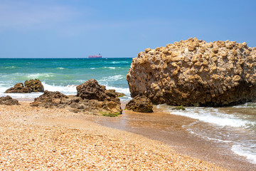 Sea waves crashing on stone formations on the shore of Ashkelon National Park