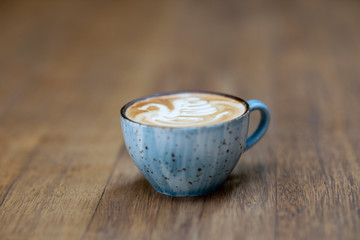 blue coffee mug on the wooden table