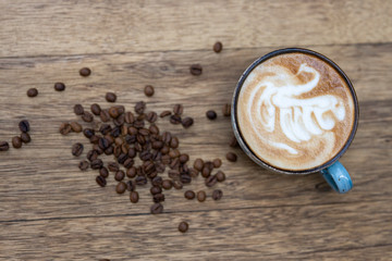blue coffee mug and coffee beans