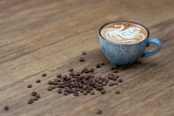 blue coffee mug and coffee beans