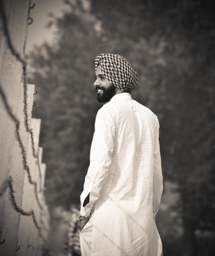 An Indian Punjabi Boy Looking Across The Border In A Field