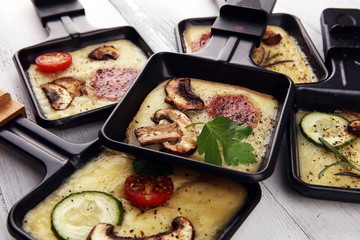 Delicious traditional Swiss melted raclette cheese on diced boiled or baked potato.