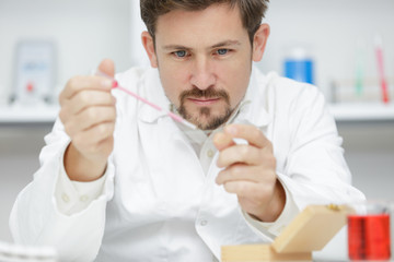 professioanl researcher distributing liquid while working in a lab