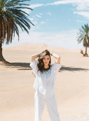 Beautiful woman in white clothes in desert.