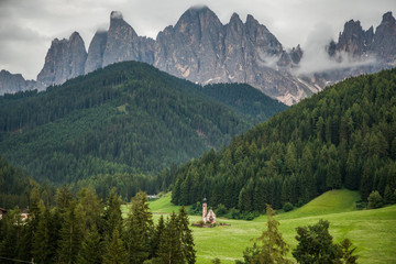 Fototapeta na wymiar Dolomites, Italy - July, 2019: Famous best alpine place of the world, Santa Maddalena village with Dolomites mountains in background, Val di Funes valley, Trentino Alto Adige region, Italy, Europe