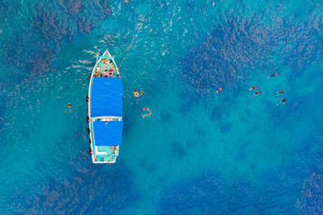 Top view of the yacht and divers in the open sea.