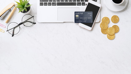 Concept of online payment with credit card with smart phone, laptop computer on office desk on...