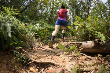 Woman trail runner running in tropical forest © lzf