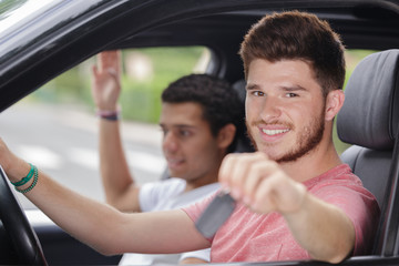 young driver showing car keys