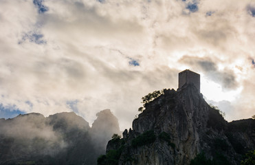 La Iruela Castle between clouds and fog, Sierra de Cazorla, Jaen, Andalusia, Spain.