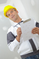 portrait of a builder in with clipboard