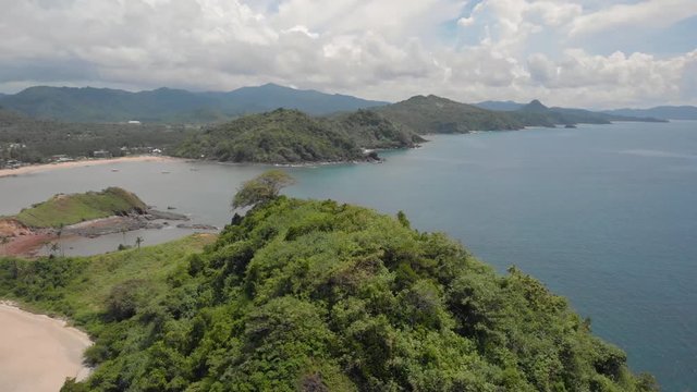 Green lush vegetation, hills and tropical beaches in El Nido at Nacpan and Twin Beach, aerial shot in Palawan, Philippines