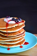 Delicious pancakes with sour cream and berries.