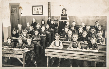 Children classmates teacher classroom Vintage photo - obrazy, fototapety, plakaty